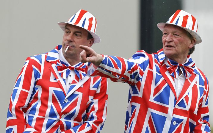Golf fans don matching Union Jack suits for early action Thursday, the first day of the British Open.