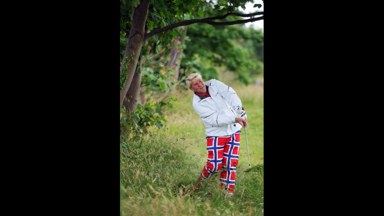John Daly of the United States attempts a shot from well off the fairway on the second hole Thursday.