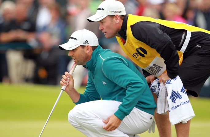 Garcia, left, lines up a putt Thursday with the help of his caddie Gary Matthews on the second green.