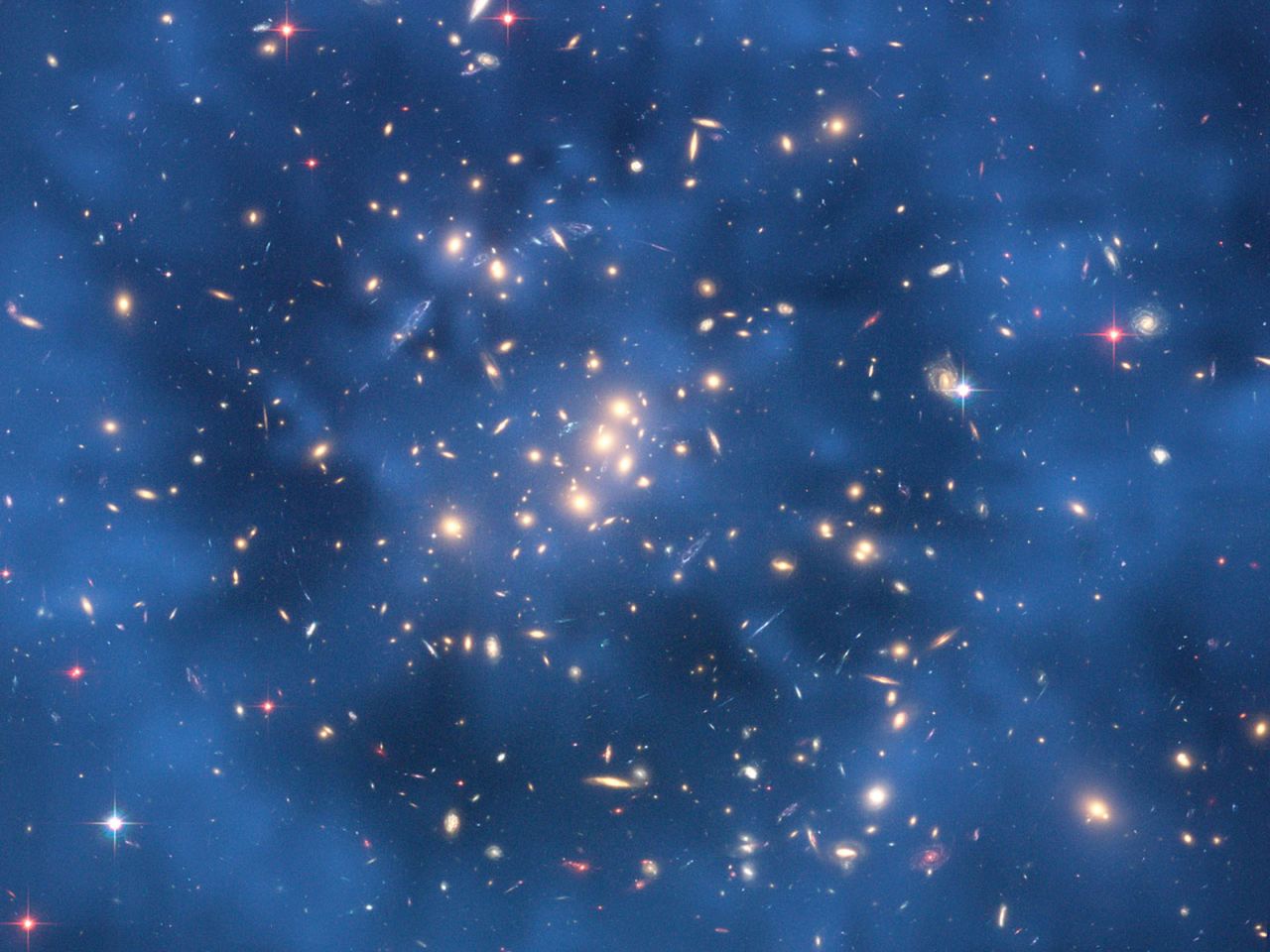 Science on the big scale and the small scale is important for understanding the structure of the universe. The Hubble Space Telescope is looking for indications of dark matter in star clusters, while particle experiments are also hunting down this mysterious substance. 