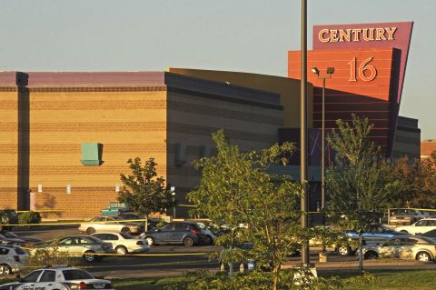Screaming, panicked moviegoers scrambled to escape from the black-clad gunman, who wore a gas mask and randomly shot as he walked up the theater's steps, witnesses said.