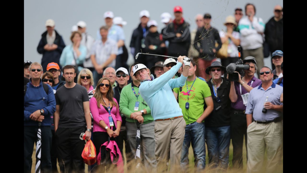 Spectators follow the flight of Snedeker's ball after a shot from the rough during the second round of the British Open on Friday, July 20