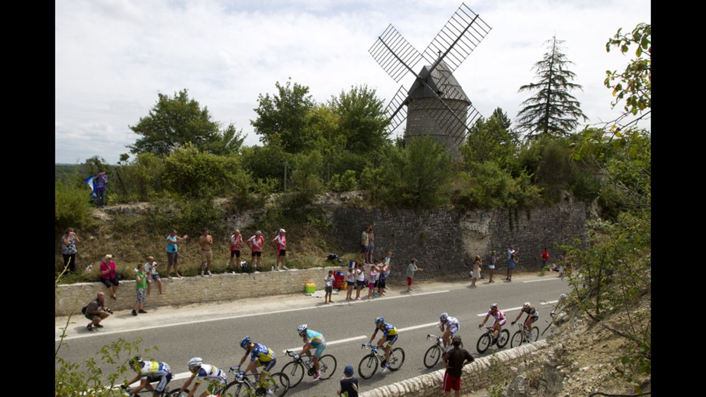 Fans cheer on the pack riding past a windmill on Friday.
