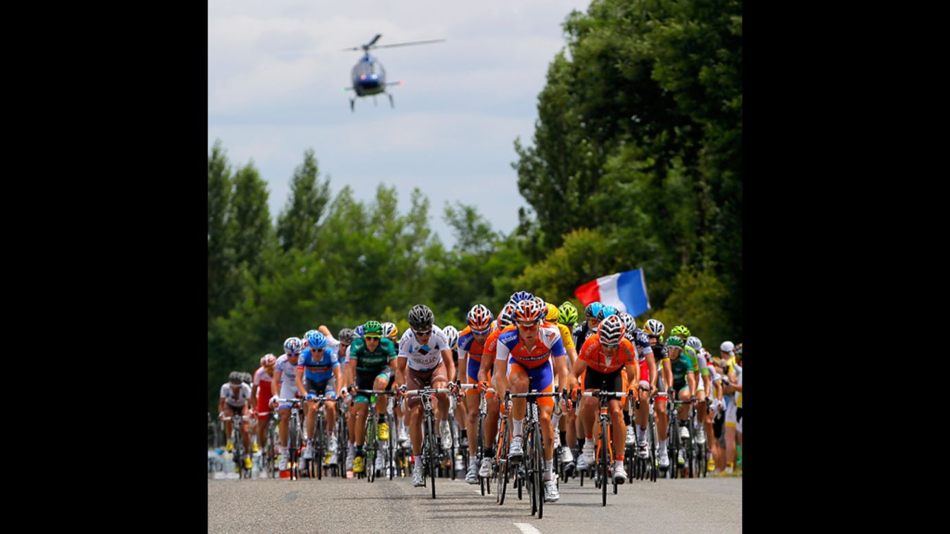 The peloton is chased by a television helicopter on Friday during stage 18.