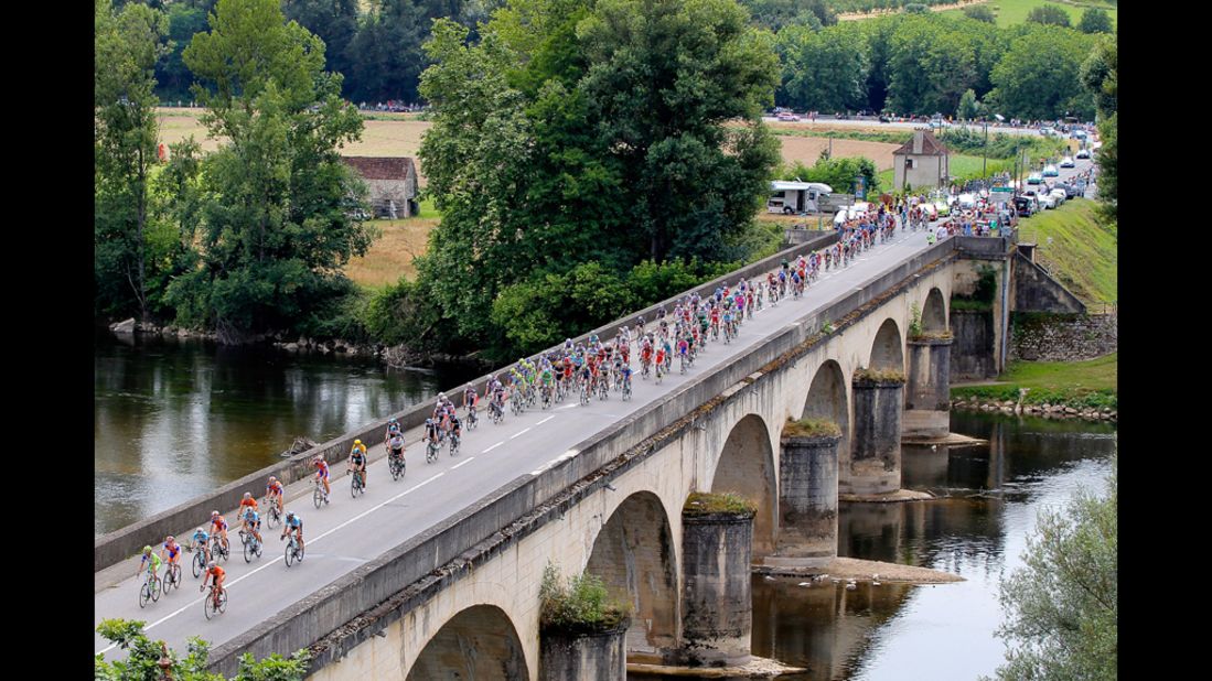 The peloton crosses La Dordogne River during Stage 18 on Friday.