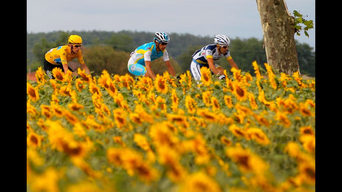 Bradley Wiggins, left, of Great Britain, riding for SKY Procycling, cycles with the peloton Friday.