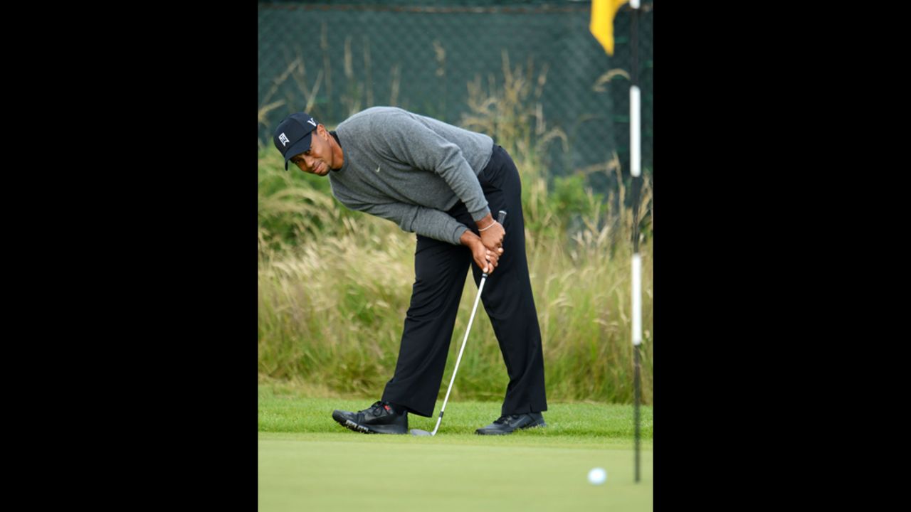 Woods intently watches his chip shot on the 14th hole during the second round.