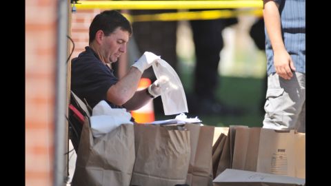 Investigators work on evidence near the apartment of James Holmes on July 20, 2012.
