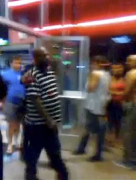 Cell phone video taken by someone at the theater showed scores of people screaming and fleeing the building. Some, like this man, had blood on their clothes.