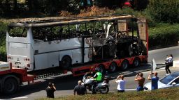 A truck carries the bus damaged by the suicide bomb blast which targeted a group of Israeli tourists in Bulgaria, on Thursday. The suicide bomber was dressed as a tourist carrying fake U.S. ID. Investigators are still trying to find out his identity. 
