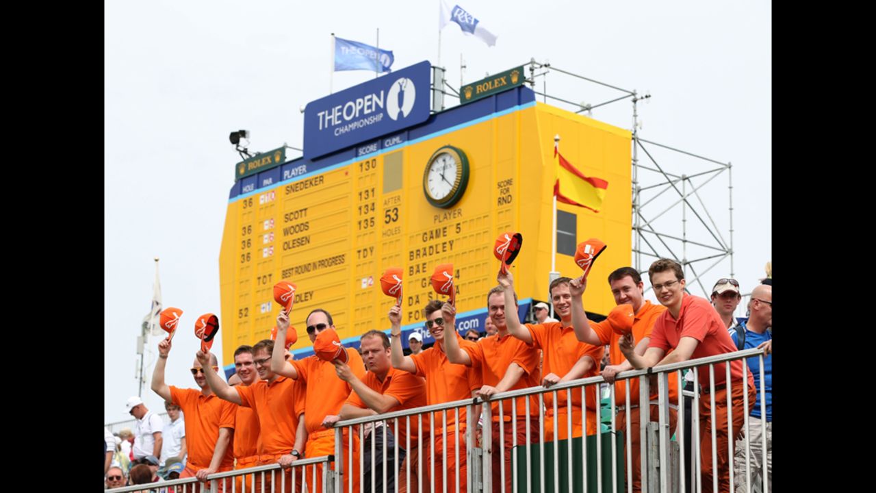 Fans of young American star Rickie Fowler fans pose in the bleachers at No. 18, dressed in their hero's customary bright, monochrome colors.