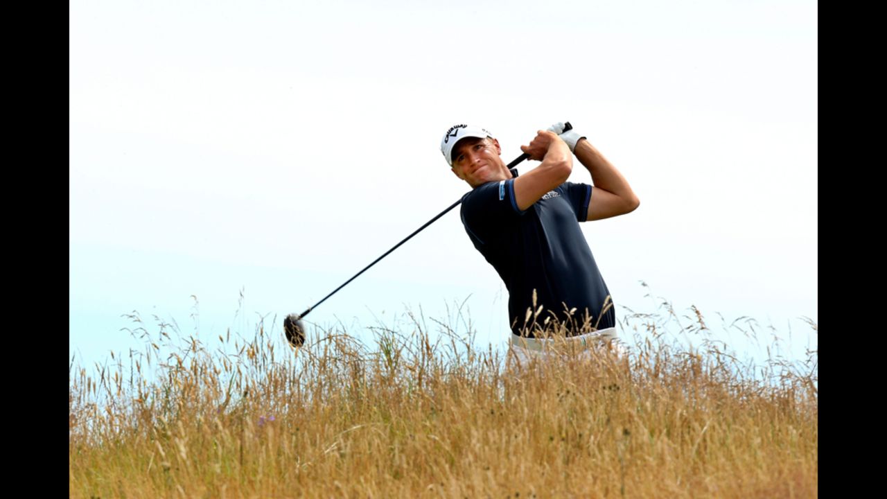 Sweden's Alexander Noren fires a fairway wood shot over the long grass at the 11th hole Saturday.