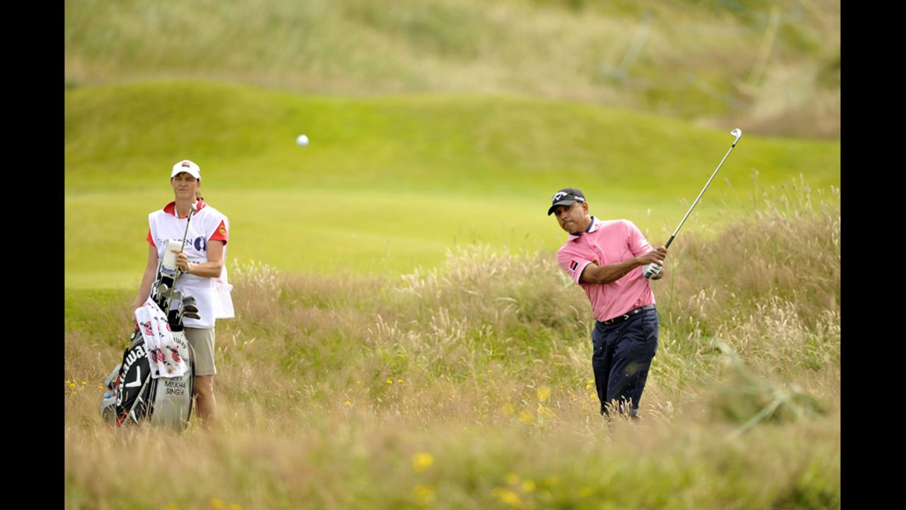 India's Keev Milkha Singh tries to escape from deep rough.