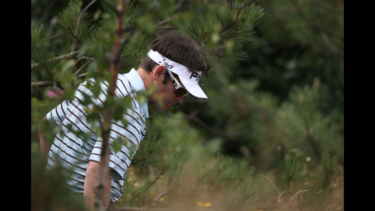 Louis Oosthuizen of South Africa searches for a lost ball on the third hole. Oosthuizen, the 2010 Open champion, was tied with several players in 10th place after Saturday's play.