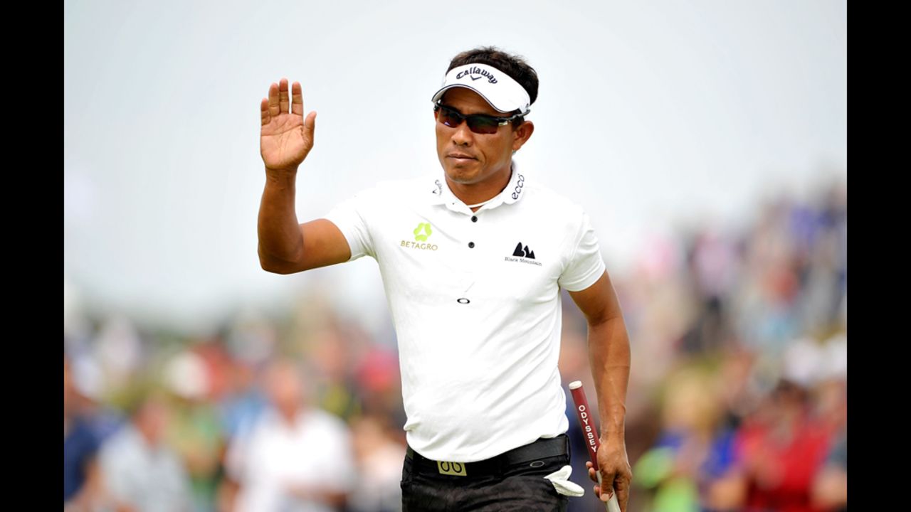 Golfer Thongchai Jaidee of Thailand waves to the gallery after making a putt on Saturday.