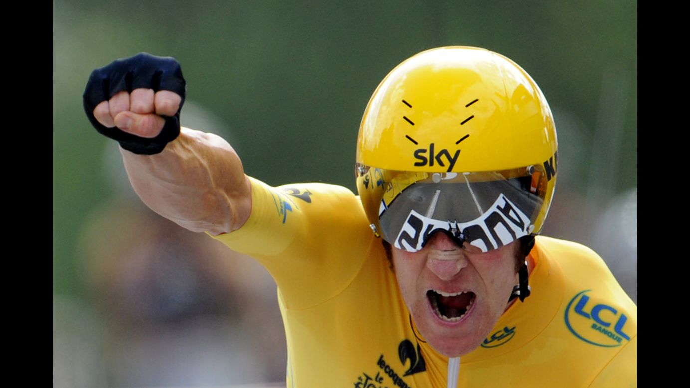 Briton Bradley Wiggins, wearing the leader's yellow jersey, celebrates finishing the 19th stage of the 2012 Tour de France on Saturday, July 21.