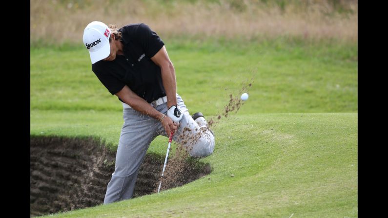 Olesen blasts out of a bunker at the third hole.