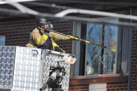 Police break a window at the suspect's apartment July 20, 2012, in Aurora.