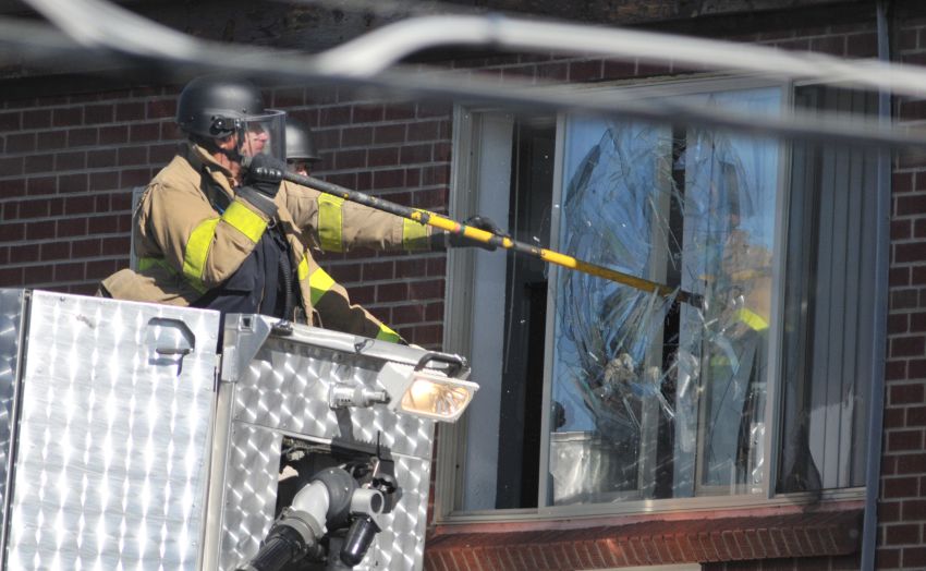 Police break the apartment window of James Holmes, the suspect of a movie theatre shooting Friday in Aurora, Colorado.
