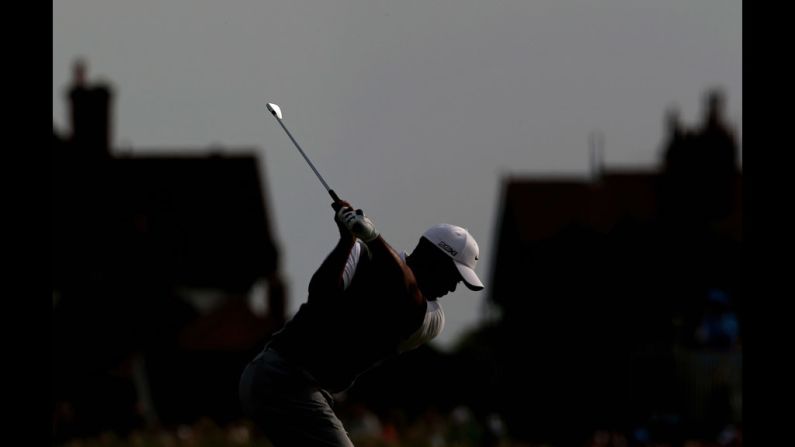 Tiger Woods hits his second shot on the 17th hole on Saturday. Woods finished the third round alone in fourth place, five shots behind Adam Scott.