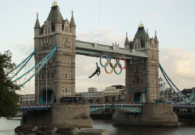 British Royal Marine Martyn Williams abseils from a helicopter with the Olympic flame into the grounds of the Tower of London on day 63 of the 70-day relay, which has involved 8,000 torchbearers.