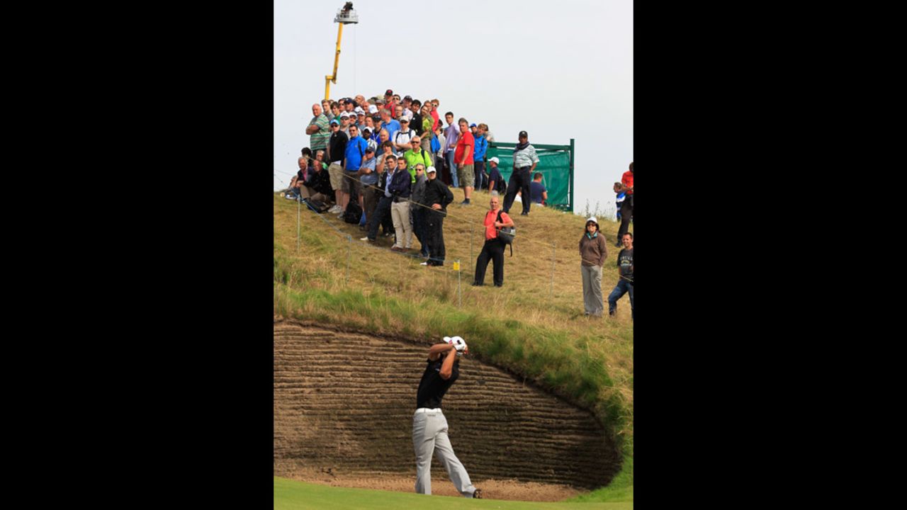 Spectators watch Olesen extract himself from one of Royal Lytham & St. Annes' many bunkers on Saturday.