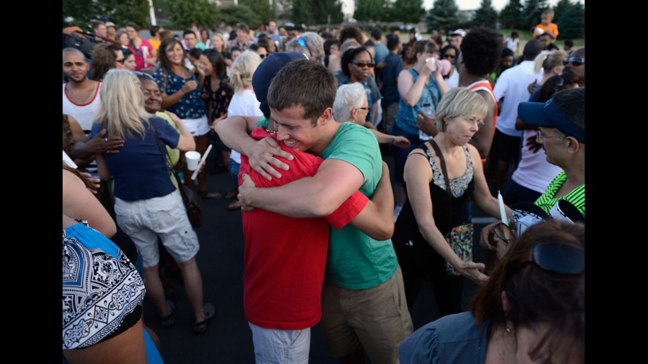 People hug during a vigil for the victims.