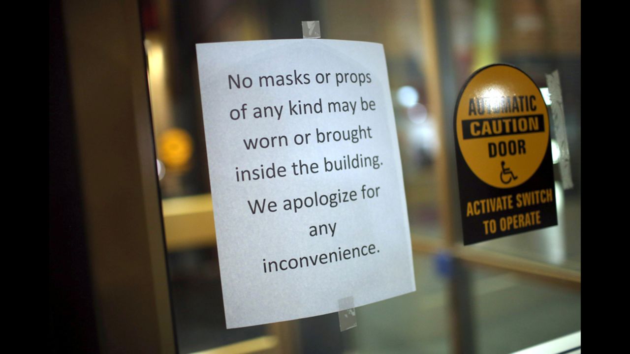 A sign prevents moviegoers from wearing masks or bringing in props to the AMC Arapahoe Crossing 16 movie theater in Aurora.