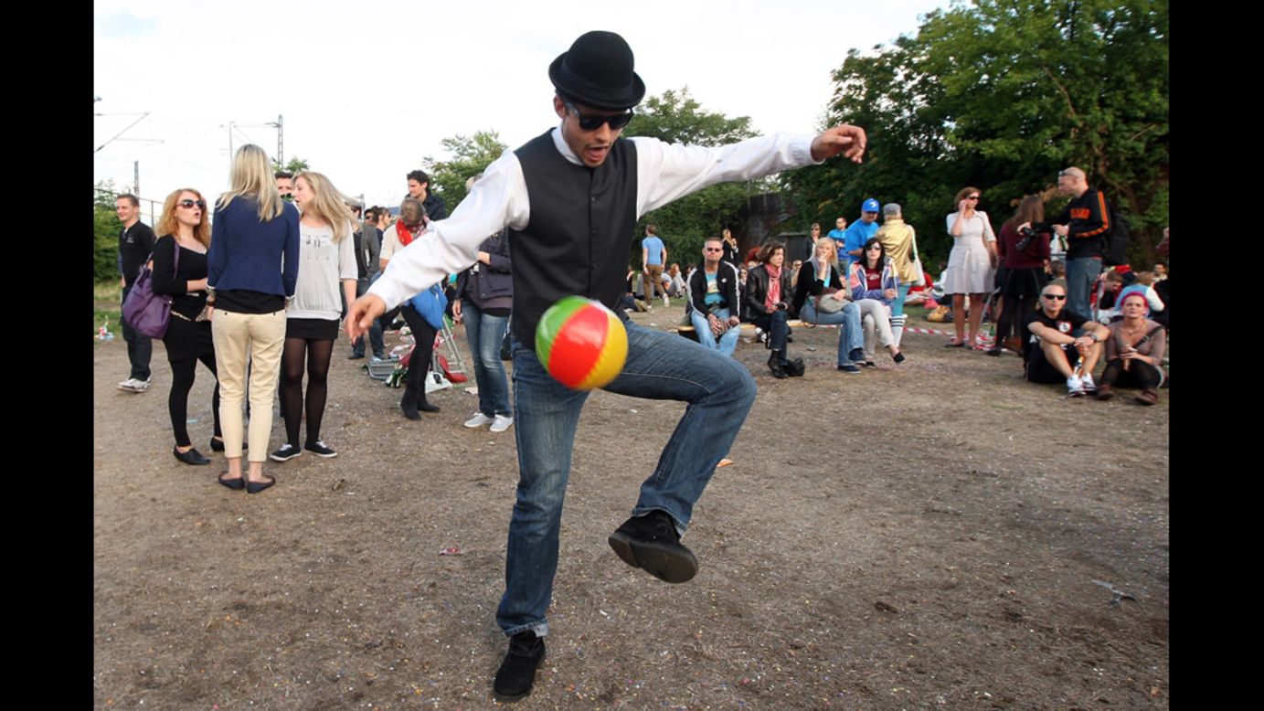 A man kicks a beach ball during the festivities.