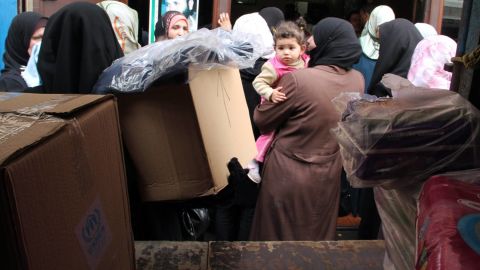 Syrian refugees wait in front of an aid supply truck in Tripoli, Northern Lebanon, in March.