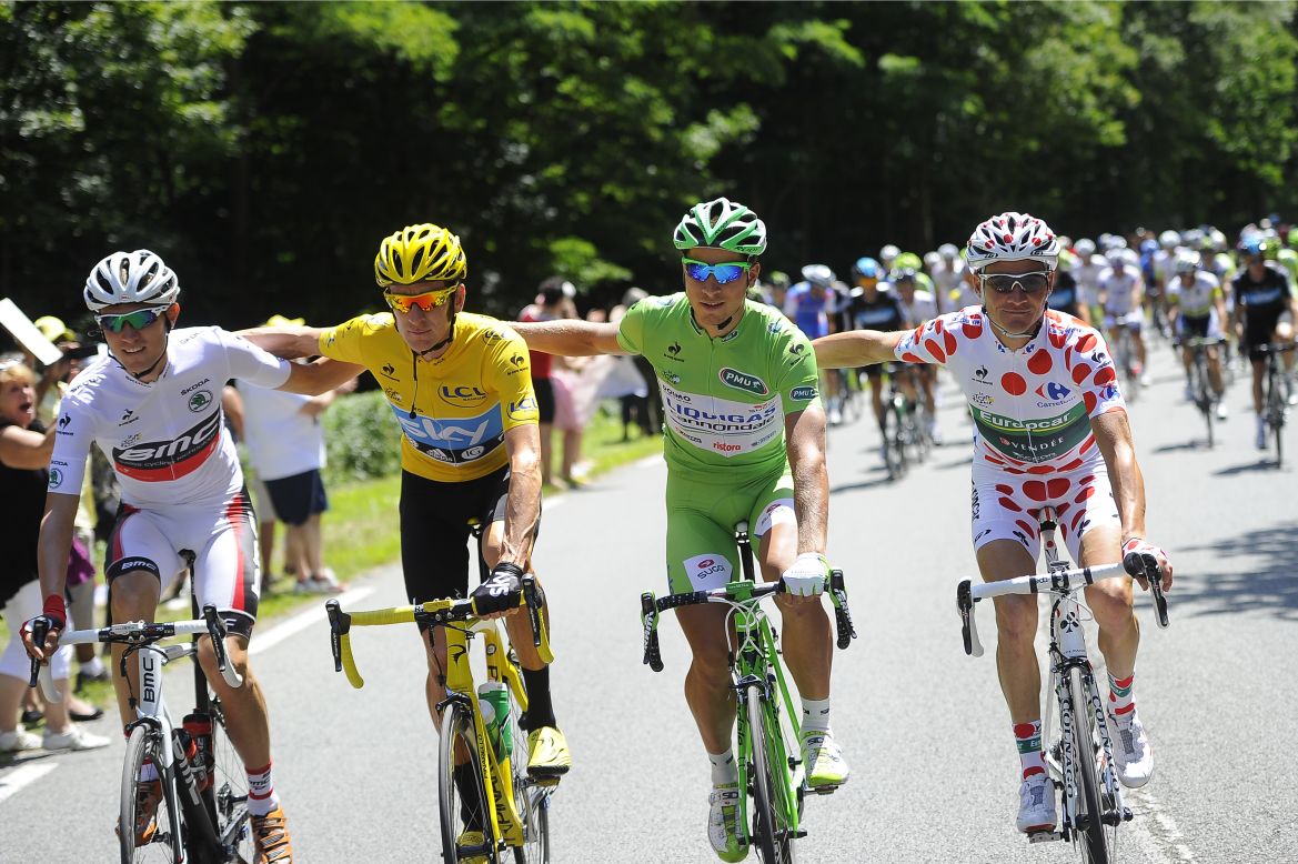 From left, best young rider Tejay Van Garderen of the United States, overall race leader Bradley Wiggins of Great Britain, best sprinter Peter Sagan of Slovakia and best climber Thomas Voeckler of France ride together the final stage, which is largely ceremonial.