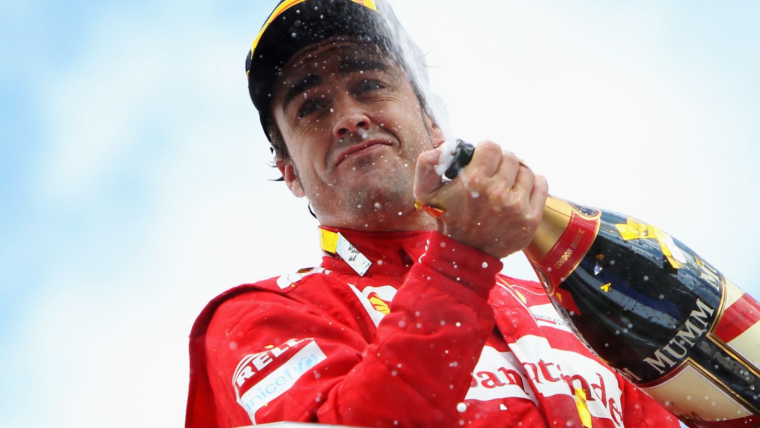 Fernando Alonso celebrates in traditional style after winning the German Grand Prix at Hockenheim for Ferrari.