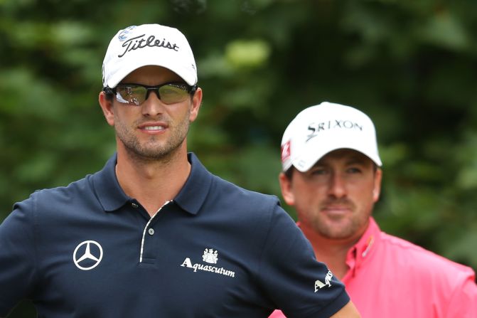 Overall leader Scott, left, waits with McDowell on the first tee during the final round of play.