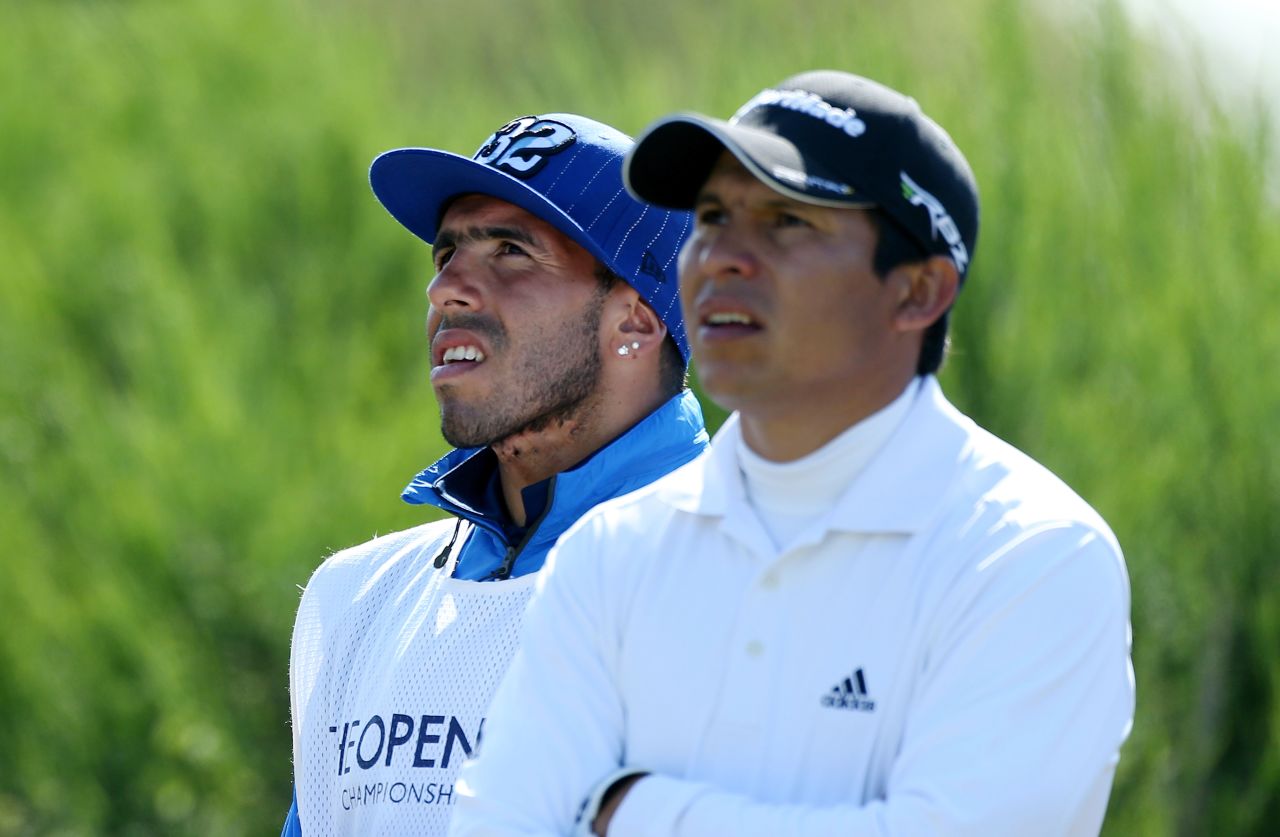 Andres Romero of Argentina, right, and his guest caddie, soccer player Carlos Tevez of Manchester City, watch the action from the tee on the 12th hole Sunday.