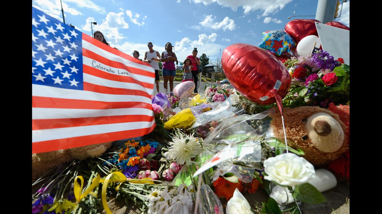 Tiffany Garcia, right, and her 6-year-old daughter, Angelina Garcia, cry on Saturday, July 21, as they look at a memorial for the victims of Friday's shooting.