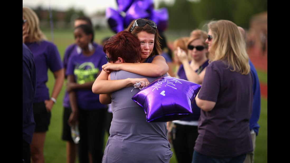 Family, friends and former classmates of movie theater shooting victim A.J. Boik gather for a memorial service at Gateway High School on Saturday.
