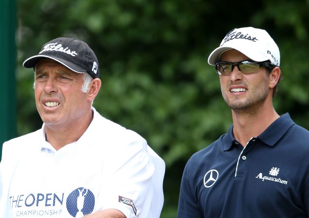 Scott and caddie Steve Williams watch the action on the first hole Sunday.