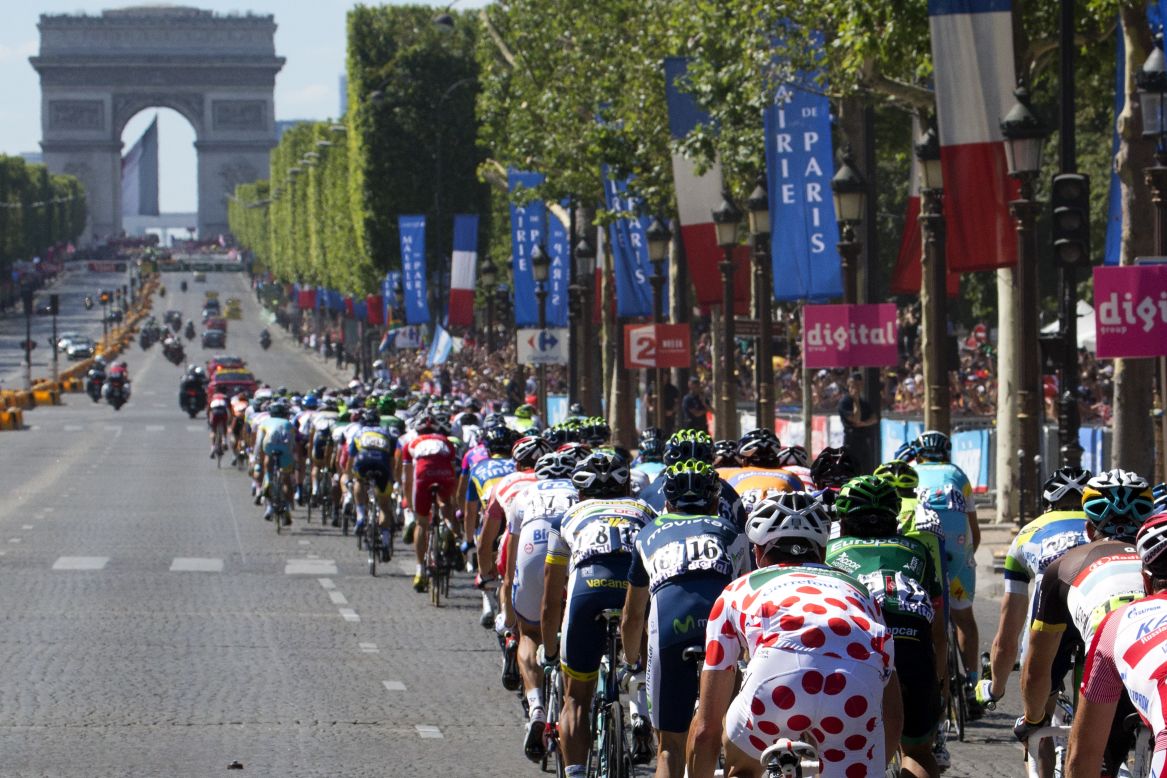 The pack of cyclists rides toward the Arc de Triomphe on the Champs-Elysees in Paris on Sunday.