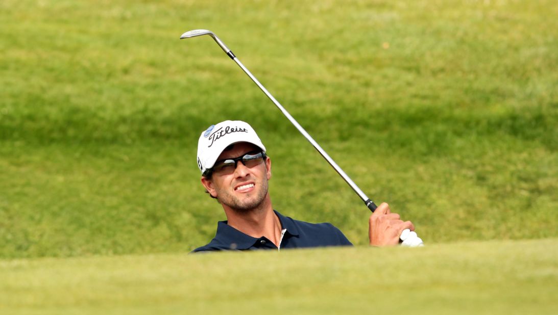Adam Scott plays out of a bunker on Sunday.