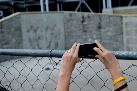 A girl takes a picture at the site where the statue of former Penn State University football coach Joe Paterno stood. It sits empty now after it was removed by workers outside Beaver Stadium on Sunday, July 22. 