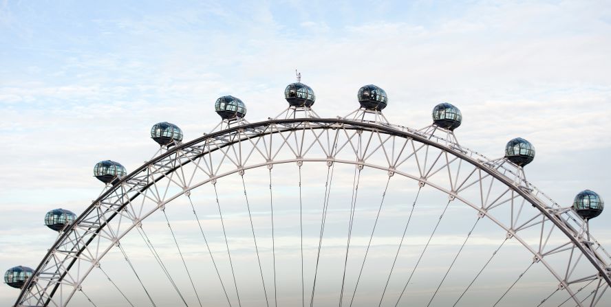 Explorer Amelia Hempleman-Adams carries the Olympic torch as she stands on the roof of a pod on the London Eye in central London on Sunday, July 22.