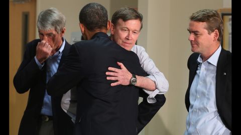 President Barack Obama embraces Colorado Gov. John Hickenlooper as Sen. Mark Udall, left, and Sen. Michael Bennet look on during a visit to the University of Colorado Hospital on Sunday.