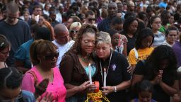 AURORA, CO - JULY 22: Titia Stillwell and Lori Meade embrace and pray with thousands of others during a prayer vigil for the victims of Friday's movie theater mass shooting at the Aurora Municipal Center July 22, 2012 in Aurora, Colorado. Suspect James Holmes, 24, allegedly went on a shooting spree and killed 12 people and injured 59 during an early morning screening of 'The Dark Knight Rises.' (Photo by Chip Somodevilla/Getty Images)