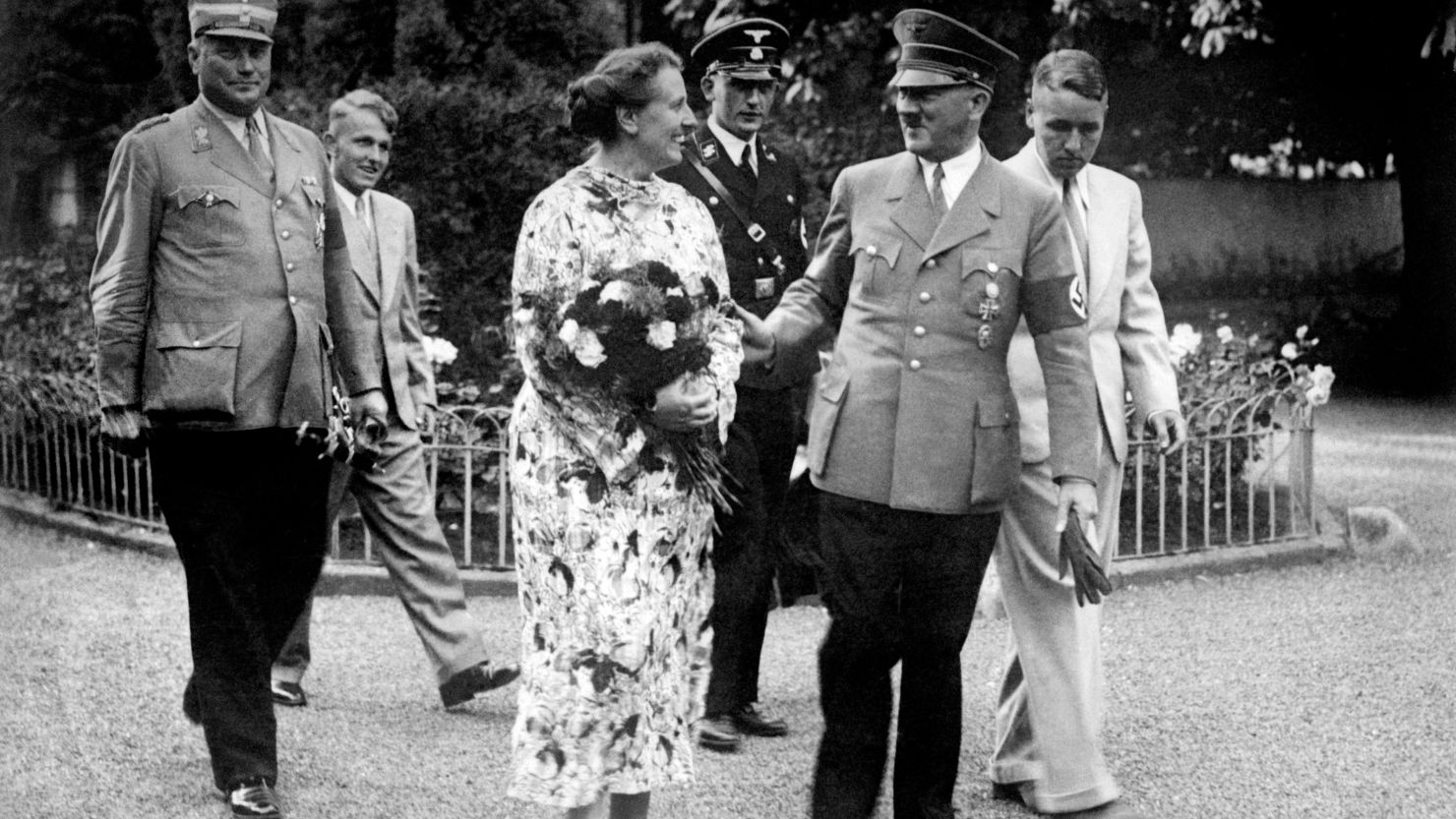German Chancellor and Nazi Dictator Adolf Hitler, second right, talking with Winifred Wagner in the park of the Wahnfried Villa in Bayreuth in summer 1937. Winifred Wagner was the daughter-in-law of Richard Wagner and director of the Bayreuth music festival. 