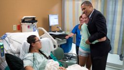 President Barack Obama hugs Stephanie Davies, who helped keep her friend, Allie Young, left, alive after she was shot during the movie theatre shootings in Aurora, Colorado, July 22, 2012.
(Official White House Photo by Pete Souza)

