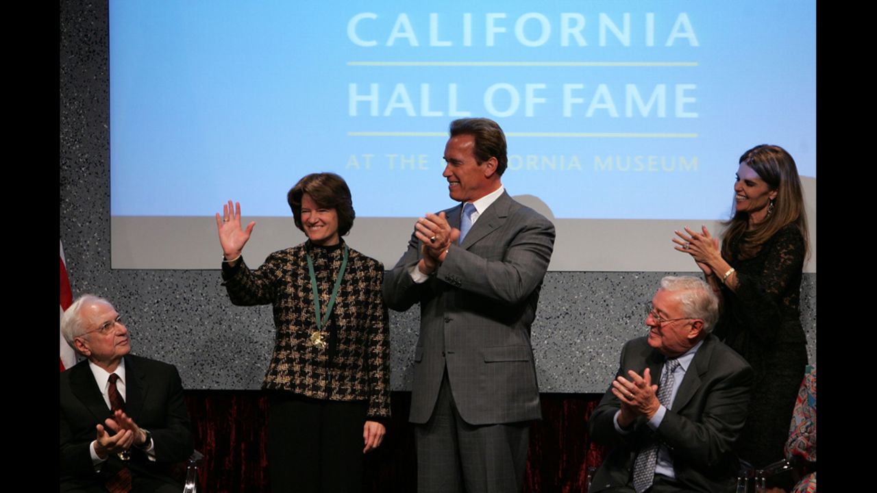 California Gov. Arnold Schwarzenegger applauds Ride after inducting her into the California Hall of Fame in December 2006.