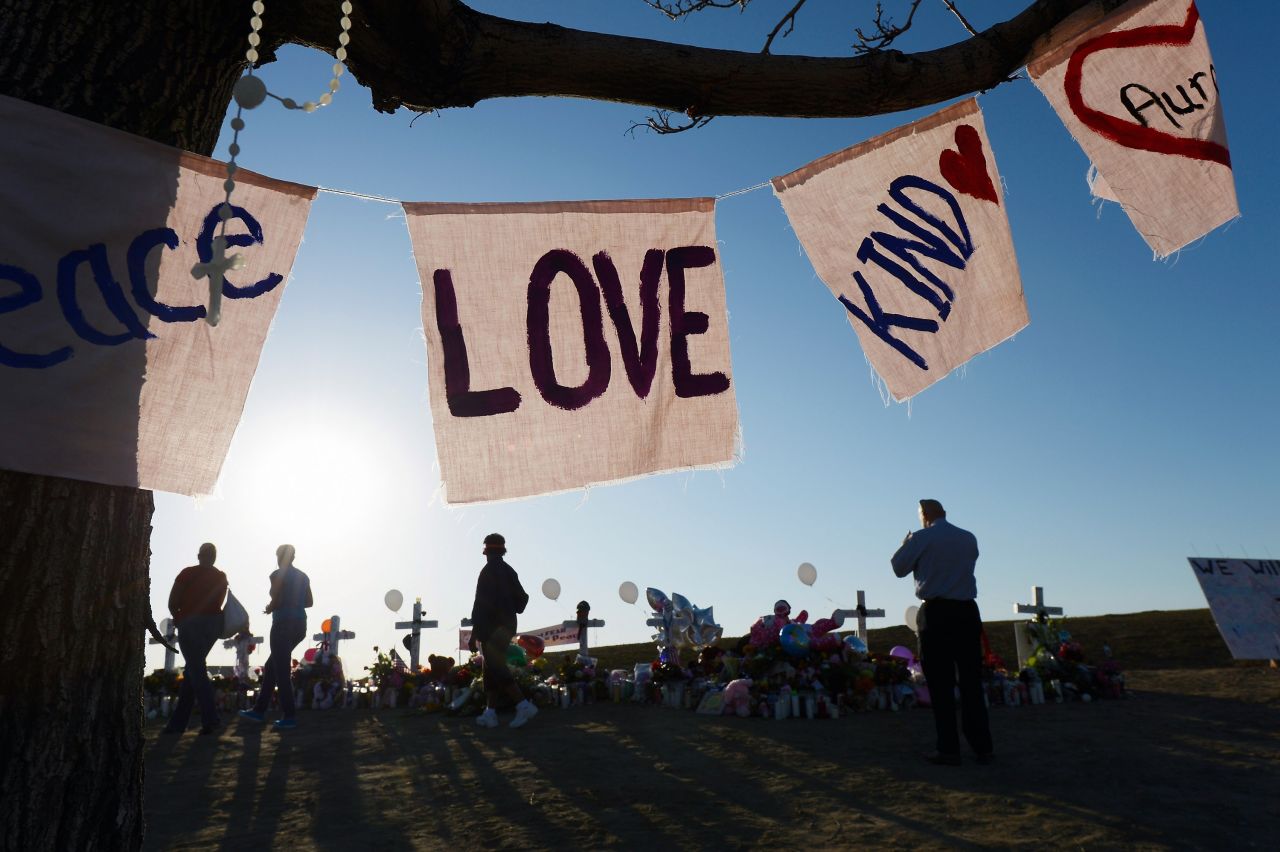Visitors pay tribute Tuesday, July 24, at the makeshift memorial.