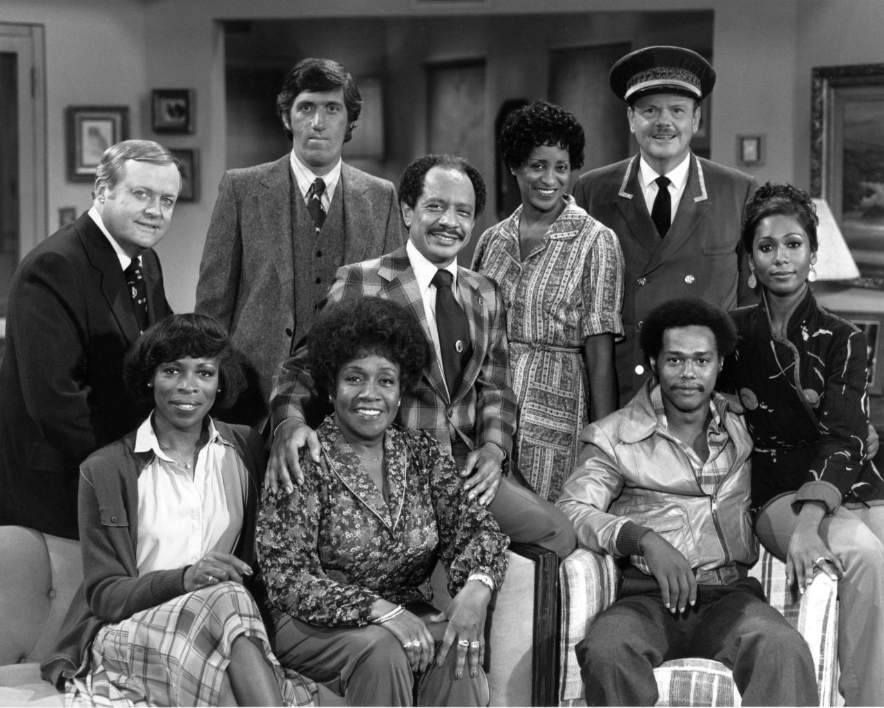 "The Jeffersons": (Back row, from left) Franklin Cover, Paul Benedict, Sherman Hemsley, Marla Gibbs and Ned Wertimer. (Front row, from left) Roxie Roker, Isabel Sanford, Mike Evans and Berlinda Tolbert.