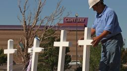 Greg Zanis places crosses at a makeshift memorial to victims of the Aurora, Colorado, movie theater shooting on Sunday, July 22. Zanis says he began building crosses to help comfort others after first creating one for himself as a memorial to his late father-in-law.