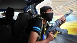 Syrian rebels hunt for snipers after attacking the municipality building in the city center of Selehattin, near Aleppo, on July 23, 2012, during fights between rebels and Syrian troops. Syrian rebels "liberated" several districts of the northern city of Aleppo on Monday, a Free Syrian Army spokesman in the country's commercial hub said.  AFP PHOTO / BULENT KILIC        (Photo credit should read BULENT KILIC/AFP/GettyImages)